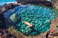 Woman floating in natural pool