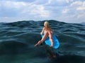 Woman floating on a surfboard