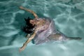 Woman floating under water arms out Royalty Free Stock Photo