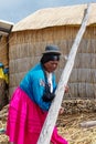 Woman on floating Uros islands on lake Titicaca in Peru