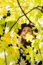 Woman in a floral patterned coat and wine red hat in the park, by the river. Happy girl, colorful autumn forest. Portrait of lady Royalty Free Stock Photo