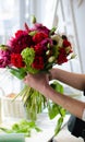 Woman florist create flower arrangement. Beautiful bouquet of mixed flowers. Floral shop concept .