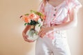 Woman florist holding vase with arrangement of fresh flowers. Bouquet of orange roses Lady of Shallott, dill Royalty Free Stock Photo