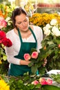 Woman florist preparing bouquet flowers shop retail