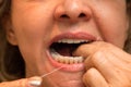 Woman Flossing her Teeth in Front of a Mirror Royalty Free Stock Photo