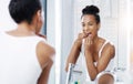 Woman flossing teeth in bathroom, mirror and oral hygiene, morning routine with product for dental health. Female person Royalty Free Stock Photo