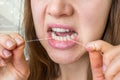 Woman flossing teeth with dental floss Royalty Free Stock Photo