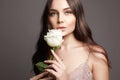 Woman with Flower. Beauty Portrait of girl with White Rose