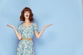 Woman in flower dress Surprised facial expression gesturing with hands short hair