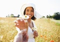 Woman, flowers and countryside with a gift, nature and plants with vacation, summer and relax. Present, person and girl
