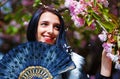 Woman with flowers, glamour white fur and black Royalty Free Stock Photo