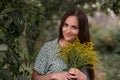 woman with flowers in hands in a summer garden Royalty Free Stock Photo