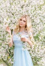 Woman in a flowery garden. Tender photo with white flowers