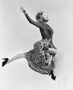 Woman in a flowing skirt leaping through the air Royalty Free Stock Photo