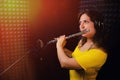 Woman flutist playing the silver flute. Record wind musical instruments with a professional microphone. Girl flute player plays in Royalty Free Stock Photo