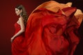 Woman Flying Dress, Elegant Fashion Model in Fluttering Red Gown Royalty Free Stock Photo