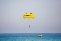 Woman flying on a yellow parachute with smiling face on it Royalty Free Stock Photo