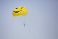 Woman flying on a yellow parachute with smiling face on it Royalty Free Stock Photo