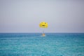 Woman flying on a yellow parachute with smiling face on it Royalty Free Stock Photo