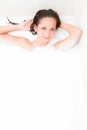 Woman on a foam bath in the tub Royalty Free Stock Photo