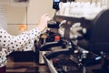 Woman foaming milk for cappuccino