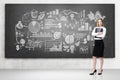 Woman with a folder and drawings on a chalkboard Royalty Free Stock Photo