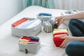 Woman folding clothes, organizing stuff and laundry in boxes