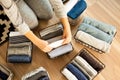 Spring cleaning of closet. Vertical tidying up storage. Neatly folded clothes in the metal black baskets for wardrobe. Wooden