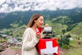 Woman with fondue in the mountains