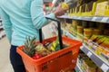 Woman with food basket and jar at grocery store Royalty Free Stock Photo