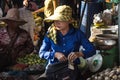 Woman on food market in Cambodia receiving money