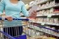 Woman with food in shopping cart at supermarket Royalty Free Stock Photo