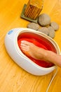 Woman foot in paraffin bath at the spa Royalty Free Stock Photo