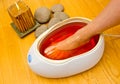 Woman foot in paraffin bath at the spa