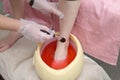 woman foot treatment in paraffin bath at the spa.