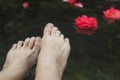 Woman foot in water, rose Royalty Free Stock Photo