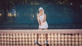 Woman forcefully playing tennis close at net