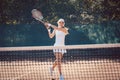 Woman forcefully playing tennis close to net Royalty Free Stock Photo
