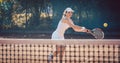 Woman forcefully playing tennis Royalty Free Stock Photo