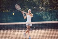 Woman forcefully playing tennis Royalty Free Stock Photo