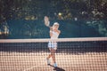 Woman forcefully playing tennis outdoors Royalty Free Stock Photo