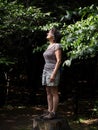 Woman Forest Bathing and Looking at Sunlight