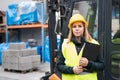 Woman forklift truck driver in an industrial area.