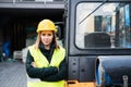 Woman forklift truck driver in an industrial area.