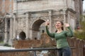 Woman in foro romano takes photos with her smartphone Royalty Free Stock Photo