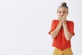 Woman freaking out seeing huge disgusting spider. Portrait of scared panicking cutie in headband and vintage red blouse