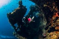 Woman free diver swim with fins at wreck ship. Freediving in ocean Royalty Free Stock Photo