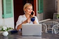 Woman freelance freelancer with laptop on the beach sitting in summer cafe .business lady remote work surfer surfing Royalty Free Stock Photo