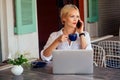 Woman freelance freelancer with laptop on the beach sitting in summer cafe .business lady remote work surfer surfing Royalty Free Stock Photo