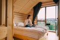 Woman freelancer in casual clothes working remotely on laptop in country wooden apartment. Female freelancer working online on Royalty Free Stock Photo